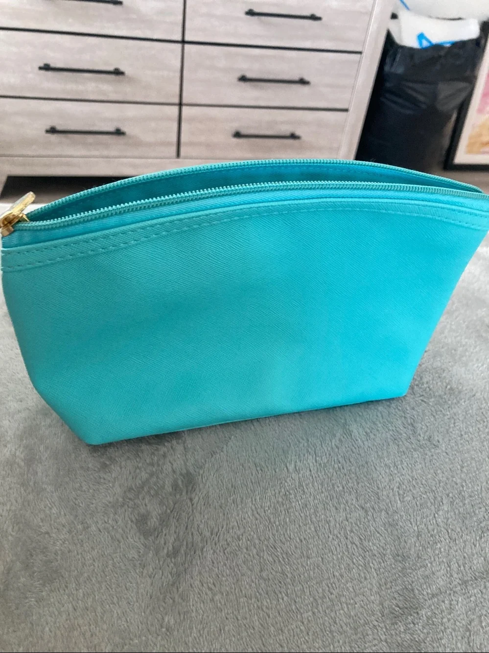 Turquoise colored faux leather cosmetic bag